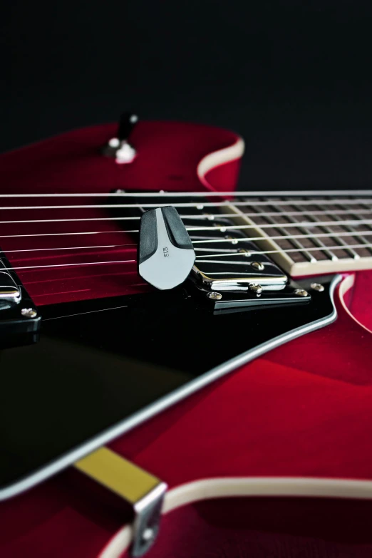 an electric guitar has a red background