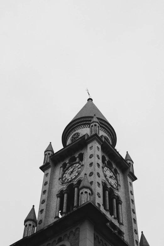 the top of a tower has clocks on each corner