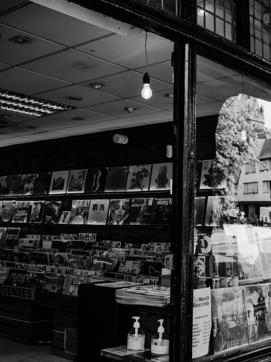 a window in a store filled with many different newspaper