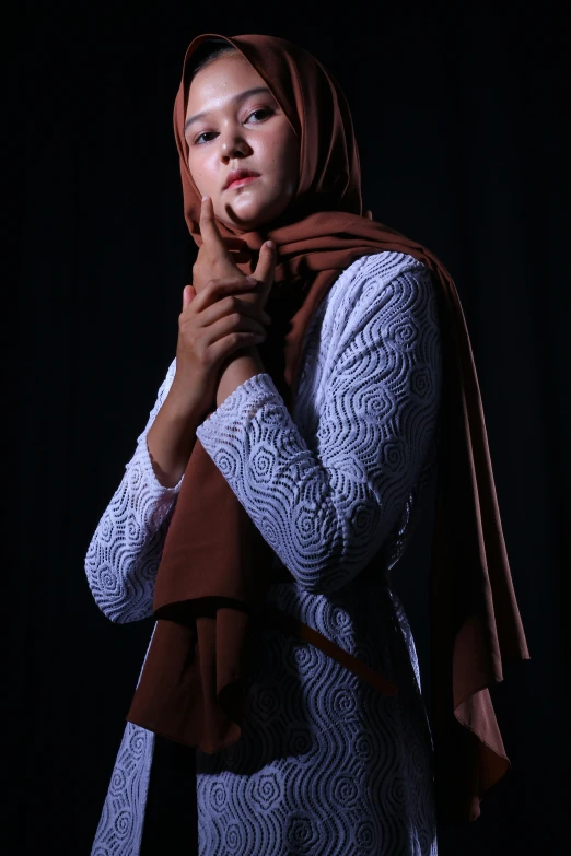 a woman with a scarf on posing for the camera