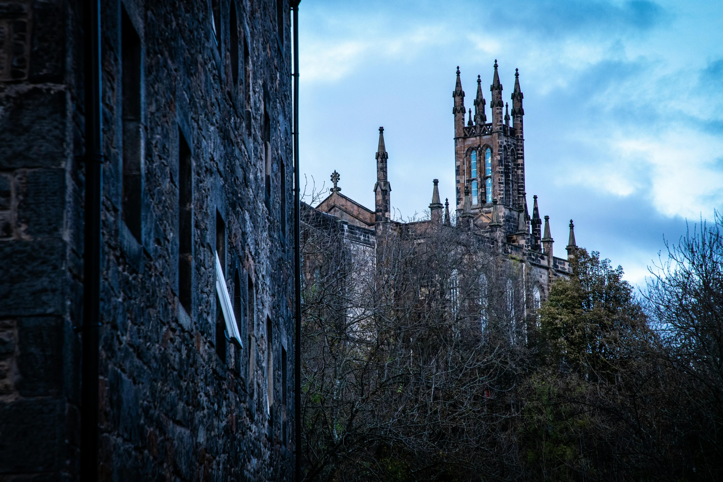 looking down from a brick building with a church steeple in the background