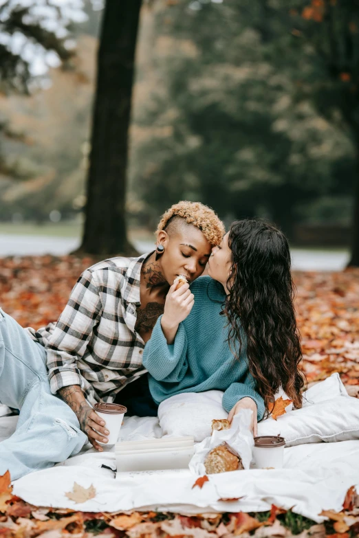 a couple having fun while eating soing on the ground