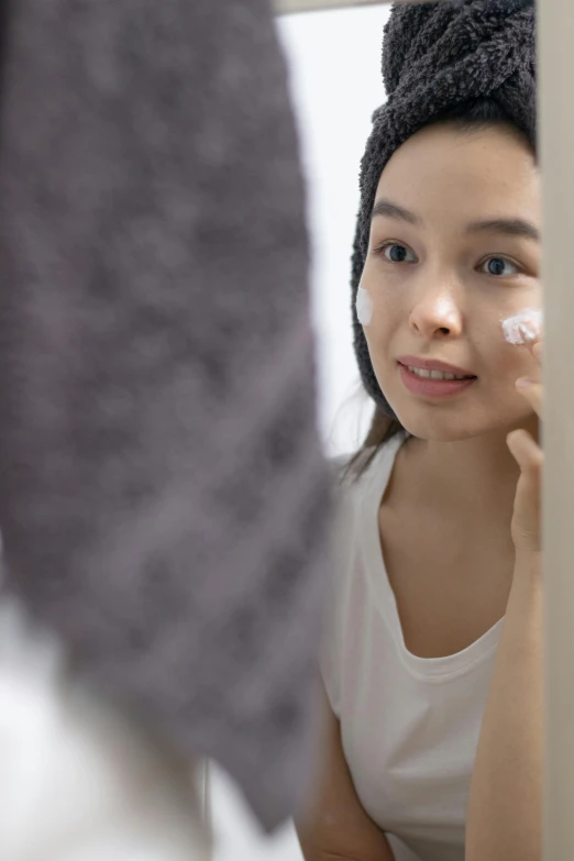 a woman is putting the finishing touches on her face