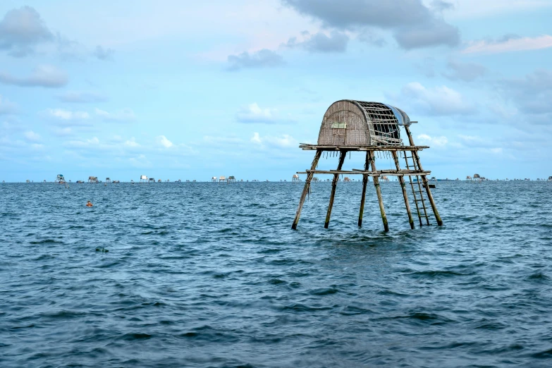 a water tower in the ocean with people in it