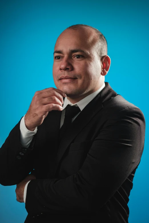 a young man posing with his arms folded