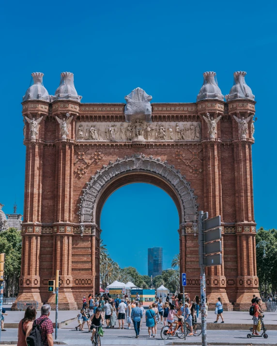 a very large arch with a very large crowd of people around it