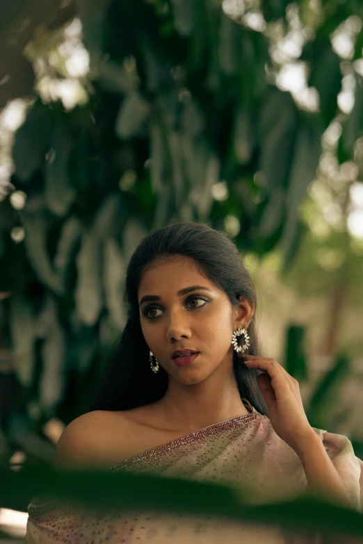 a woman with green eyes wearing earrings