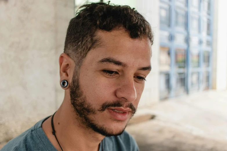 the man with a mohawk wearing a necklace and earring