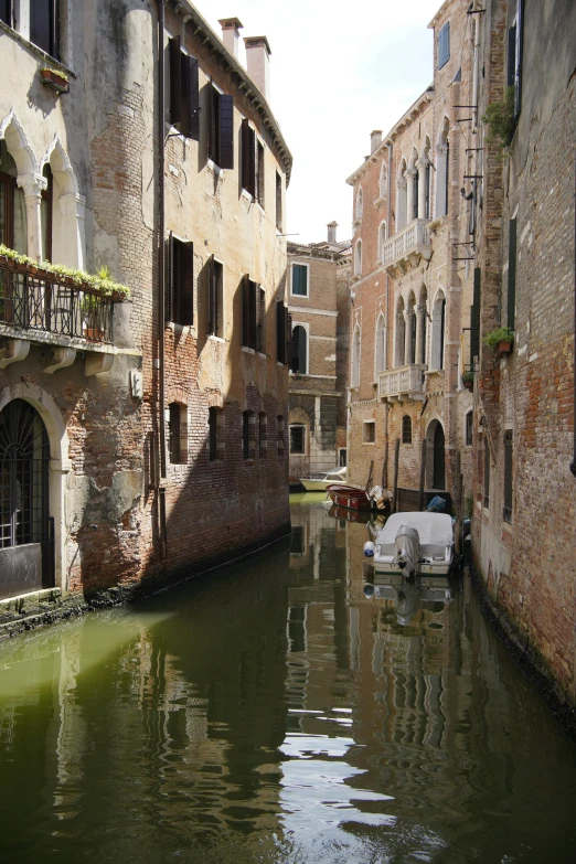 a boat in a river between two buildings