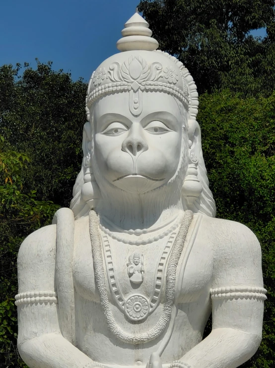 there is a statue that looks like a white buddha