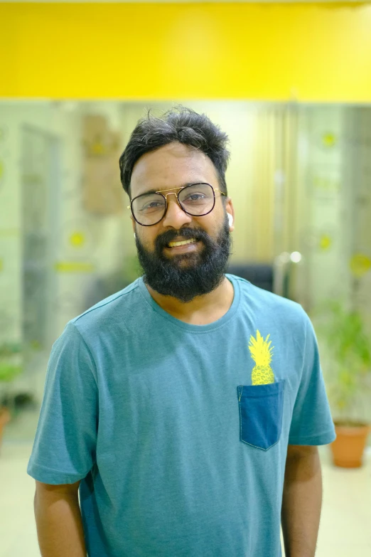 man wearing blue t - shirt with pineapple pocket