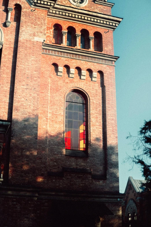 a tall brick building with a clock on it