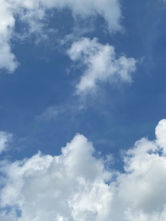 the blue sky with lots of clouds above it