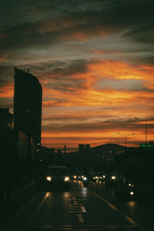 a sunset or sunset with cars driving down the road