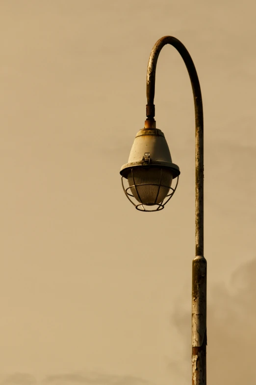 a street light with a pole and sky background