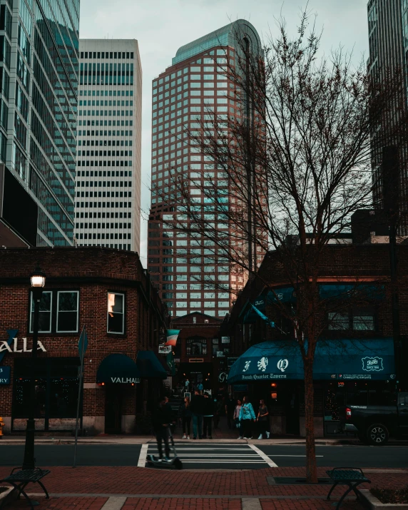 people and bicycles are walking on the side of a street