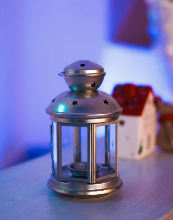 a metal lantern is sitting on the table