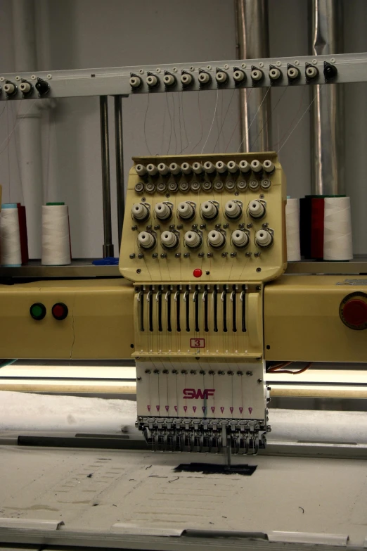 an old model machine working on yarn in a factory