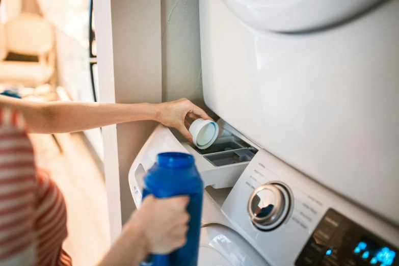 a person cleaning and dispensers some water