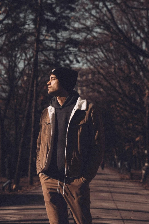 a man standing with his head up and looking off into the distance