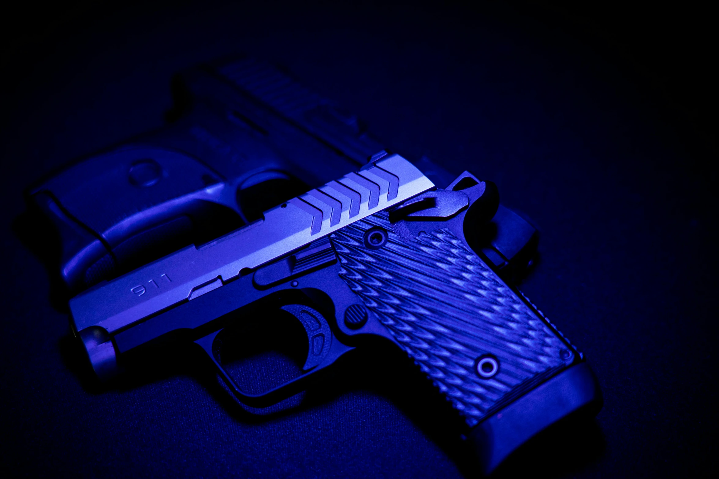 a blue toy gun sitting on a black table