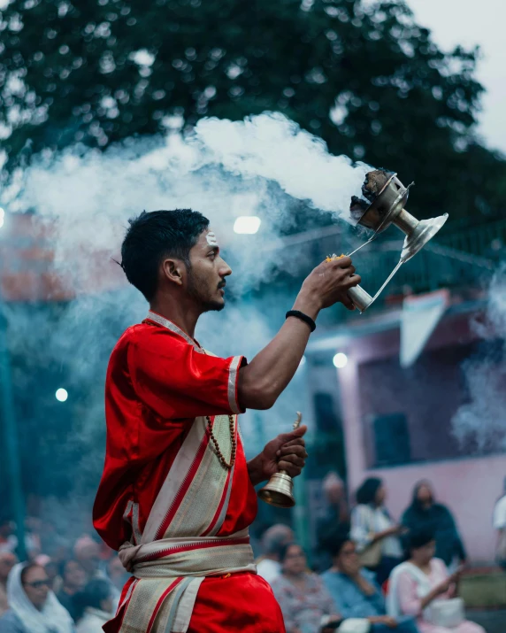 a man holds an object over a crowd