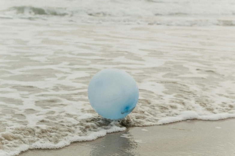 there is a blue ball sitting in the water