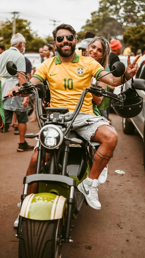 a man is riding on a motorcycle while others watch