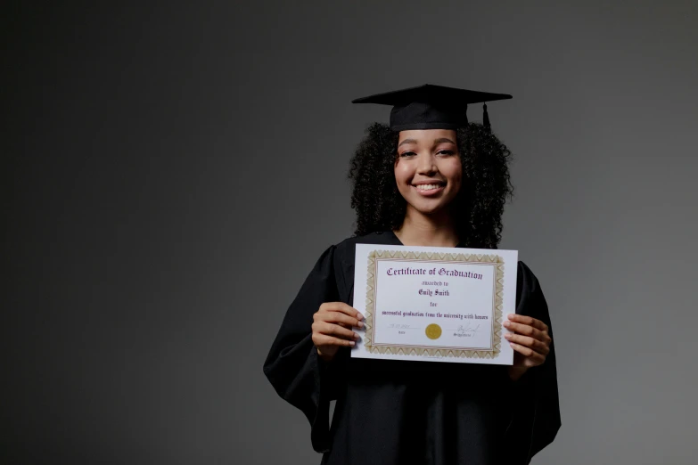  in cap and gown holding certificate