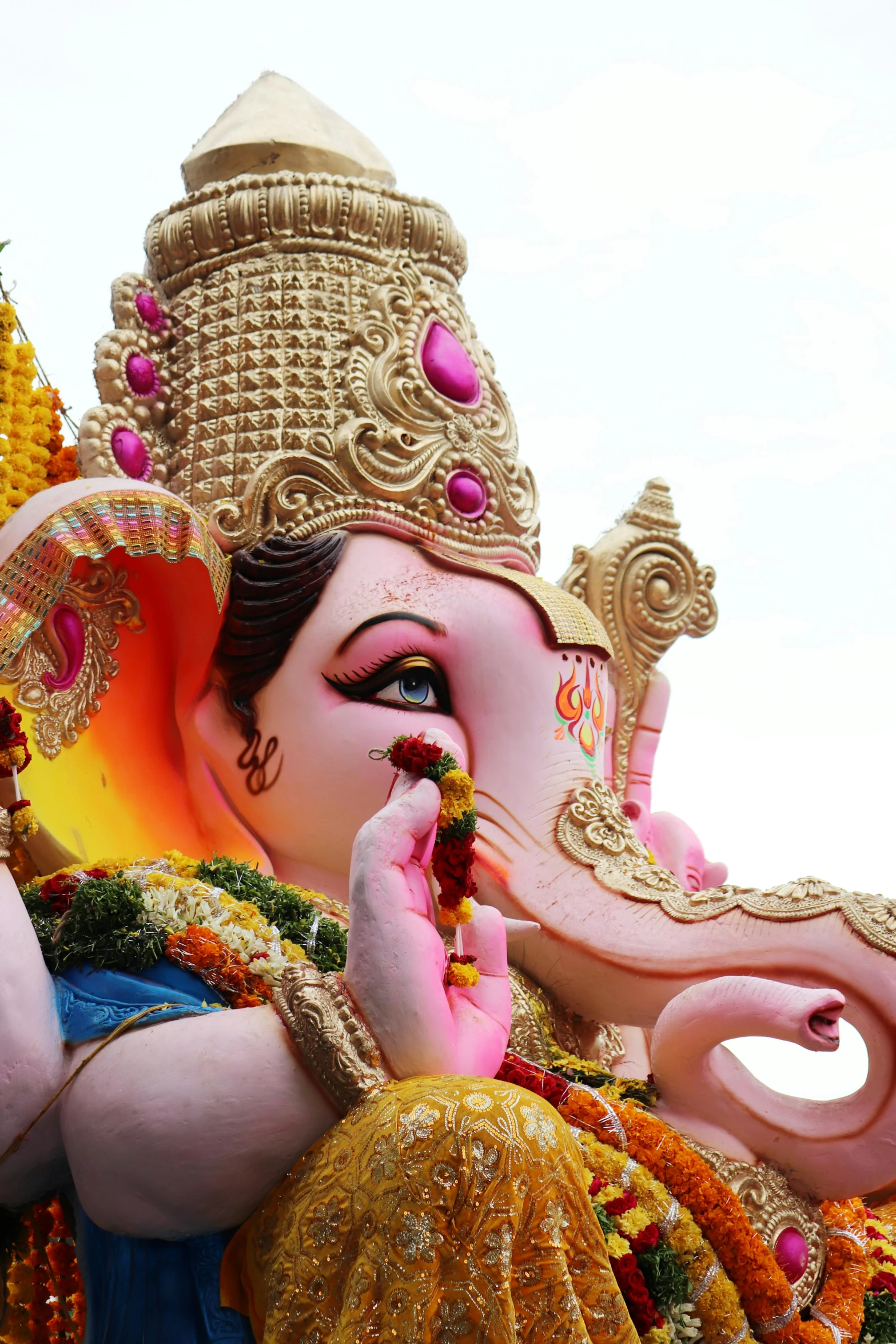 a statue of an elephant with a girl holding a flower