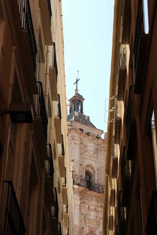 the tower of an old building with several balcony tops