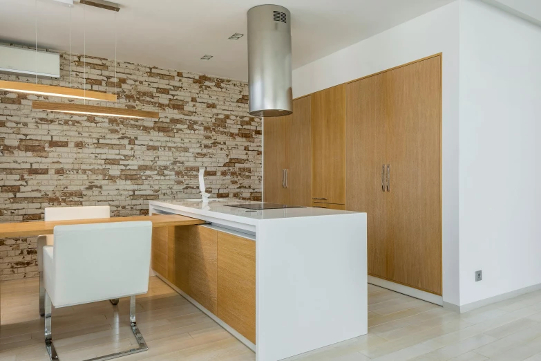 an empty kitchen with wooden cabinets and white countertops