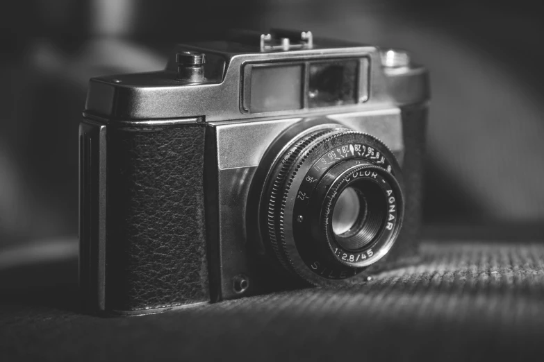 an old vintage camera on top of a couch