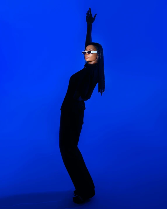 a woman in shades posing with her hands up