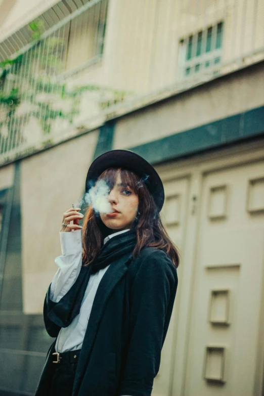 a person in black coat smoking a cigarette