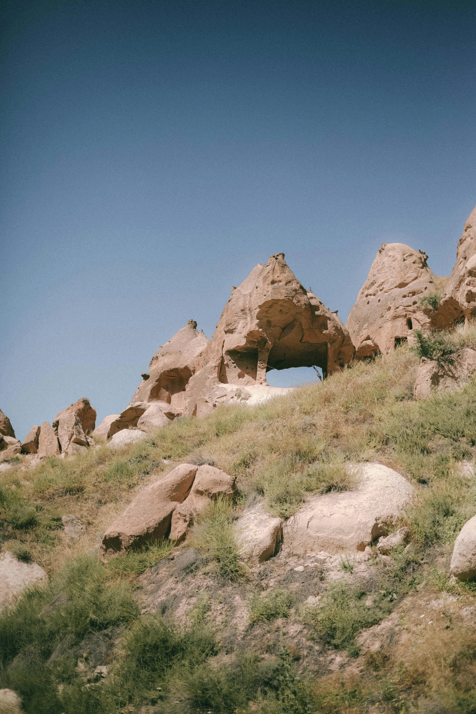 some rocks are standing in the grass