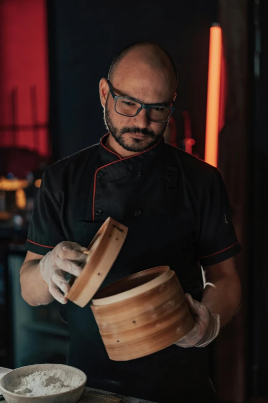 a person wearing a glove preparing food in a kitchen