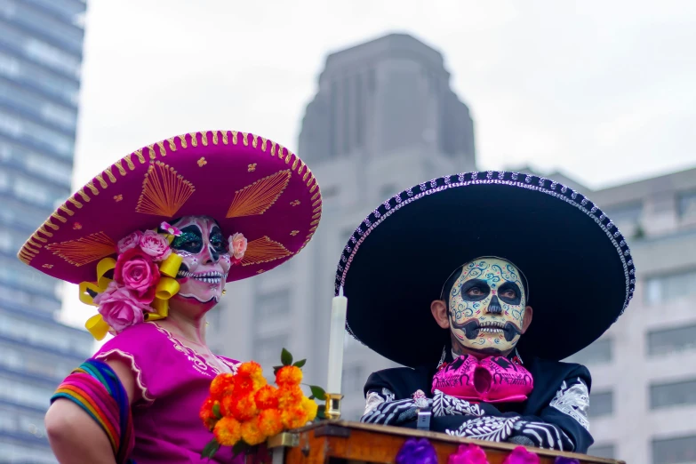 two women wearing mexican costumes during a parade