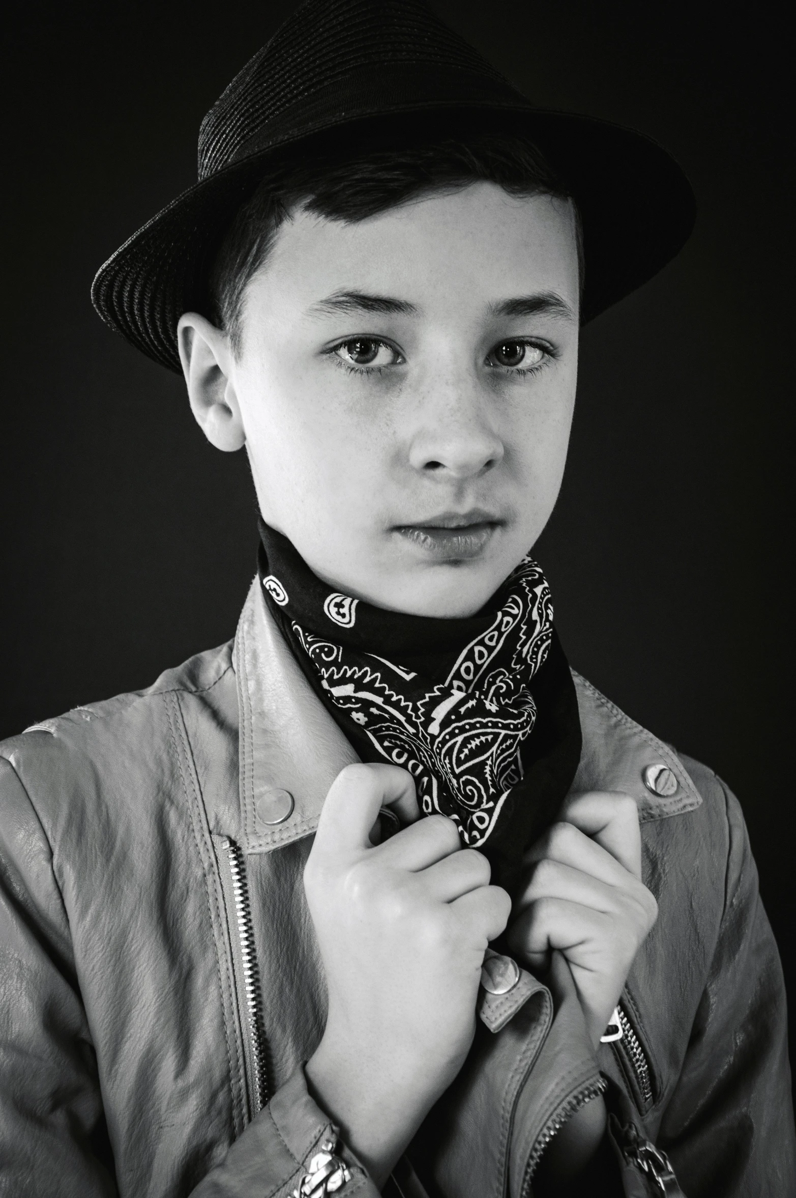 black and white po of a boy wearing a hat and a scarf