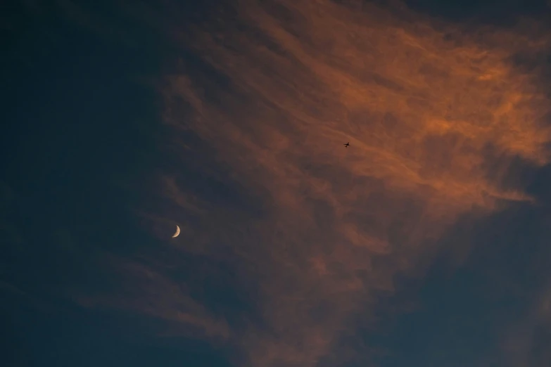 clouds and stars in the sky during sunrise or sunset