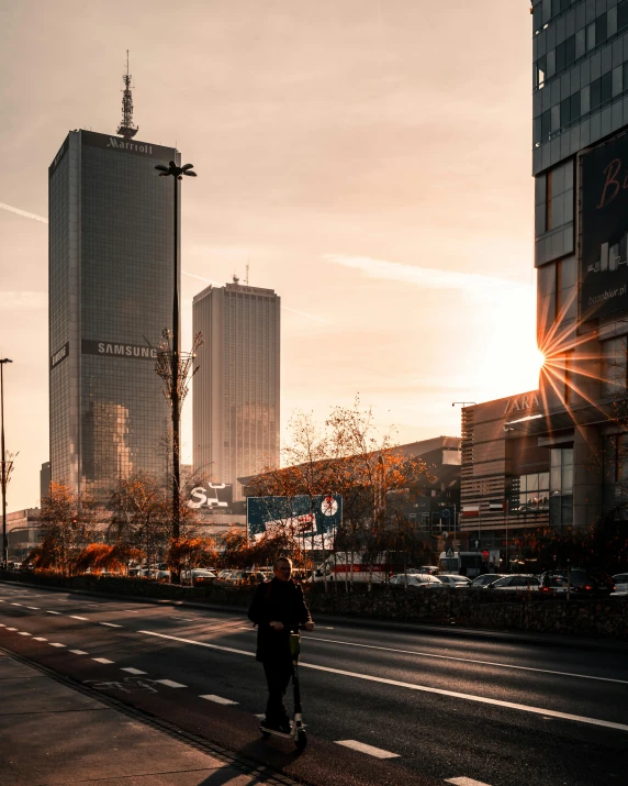 a man walking on the street in front of tall buildings