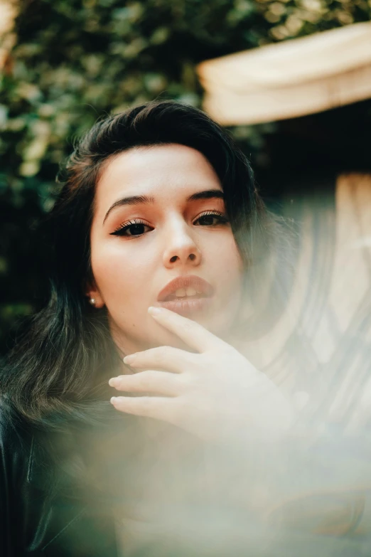 a woman poses for the camera with her eyes closed