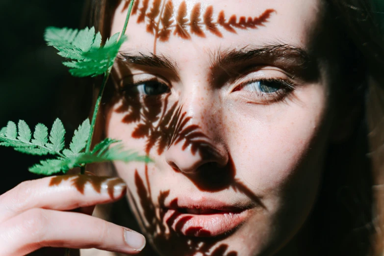 a young lady holding a plant in her hands