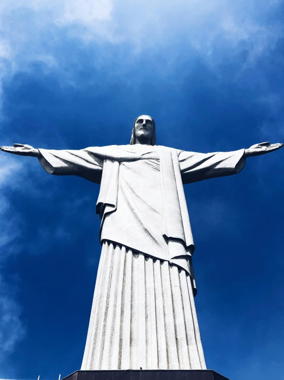 a statue with a large arms on top of a platform