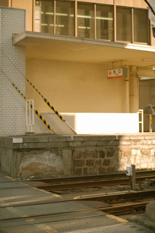 a rail way near a building on a sunny day