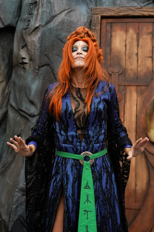 a woman in a costume posing with her hands out