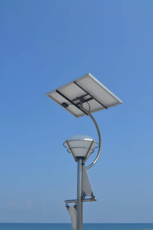 a lamp post with a view of the ocean