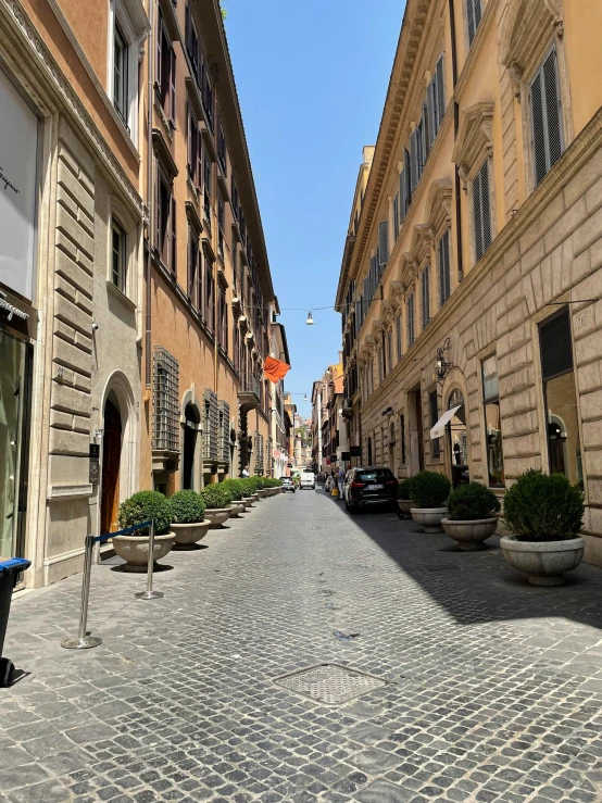 a cobblestone street is seen next to an old building