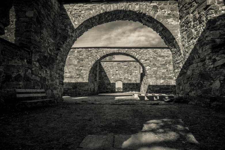 an archway leads into a field and it's grass