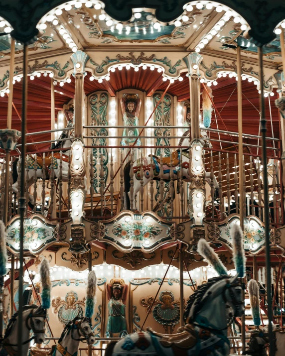 an outdoor carousel with fancy ornate artwork on the top